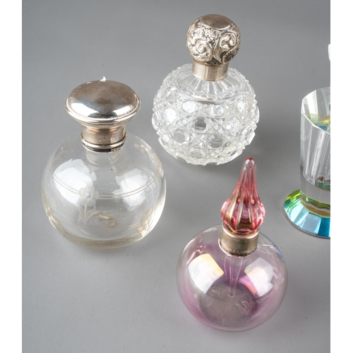 571 - A collection of nine glass scent bottles including two cut glass globular bottles with screw-on silv... 