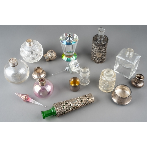 571 - A collection of nine glass scent bottles including two cut glass globular bottles with screw-on silv... 