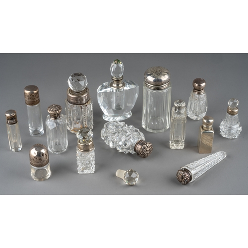 572 - A collection of assorted silver mounted cut glass scent bottles and jars, of various shapes and desi... 