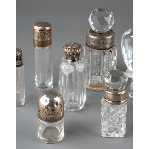 572 - A collection of assorted silver mounted cut glass scent bottles and jars, of various shapes and desi... 