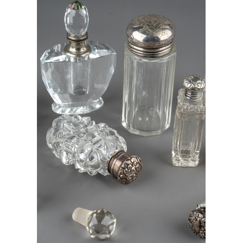 572 - A collection of assorted silver mounted cut glass scent bottles and jars, of various shapes and desi... 