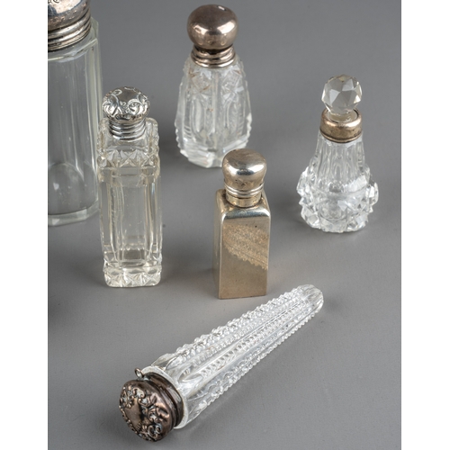 572 - A collection of assorted silver mounted cut glass scent bottles and jars, of various shapes and desi... 