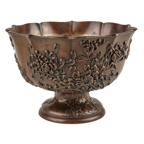 582 - Japanese bronzed pedestal bowl decorated with flowers, marked to base, approx. 18.5 cm in diameter  ... 