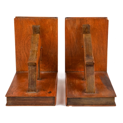 584 - A pair of mid century carved wood book ends in a form of an abstract animals. The ends and sides des... 