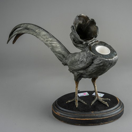 591 - An early 20th Century large patinated spelter inkwell modelled as a rooster, the head and neck hinge... 