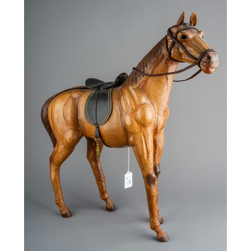 597 - A Modern leather model of a horse complete with tack, approx 51cm at highest point