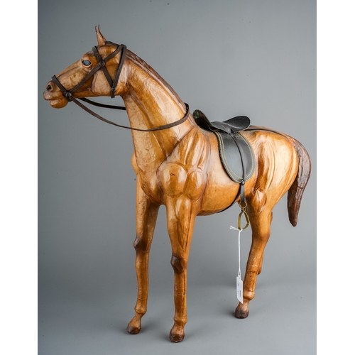 597 - A Modern leather model of a horse complete with tack, approx 51cm at highest point