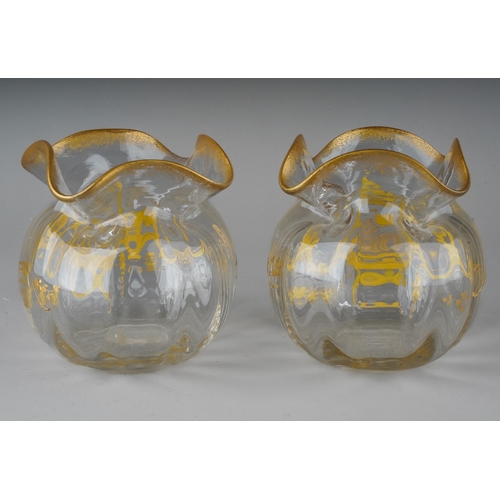 604 - A pair of early 20th Century glass vases, pinched rim, the bodies overlaid with gilt decoration, app... 