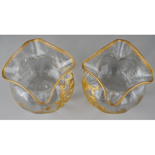 604 - A pair of early 20th Century glass vases, pinched rim, the bodies overlaid with gilt decoration, app... 