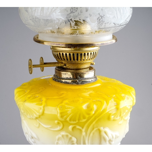 638 - A Victorian style gilt metal oil lamp, the yellow resevoir moulded with scrolling flowers, with etch... 