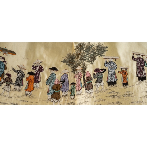 662 - An early 20th Century Chinese long cream silk panel embroidered with figures walking each wearing su... 