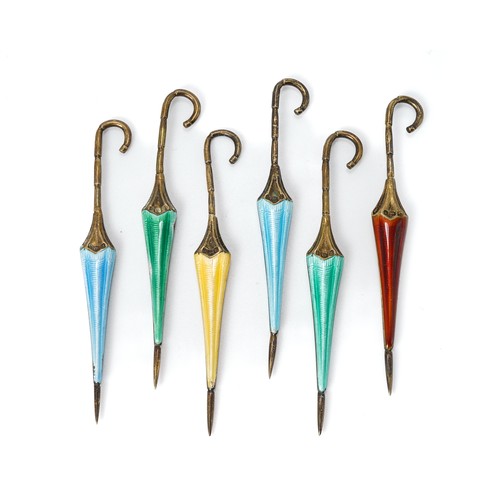 134 - A set of six silver and enamel cocktail sticks modelled as umbrellas, in green, blue, red and yellow... 