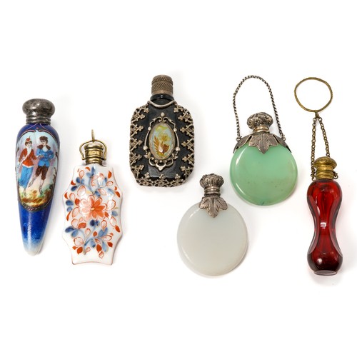 569 - A collection of six miniature scent bottles including; a 19th century red glass bottle with gilt met... 