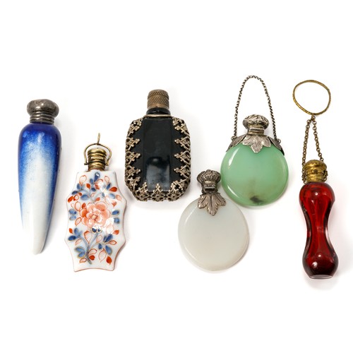 569 - A collection of six miniature scent bottles including; a 19th century red glass bottle with gilt met... 