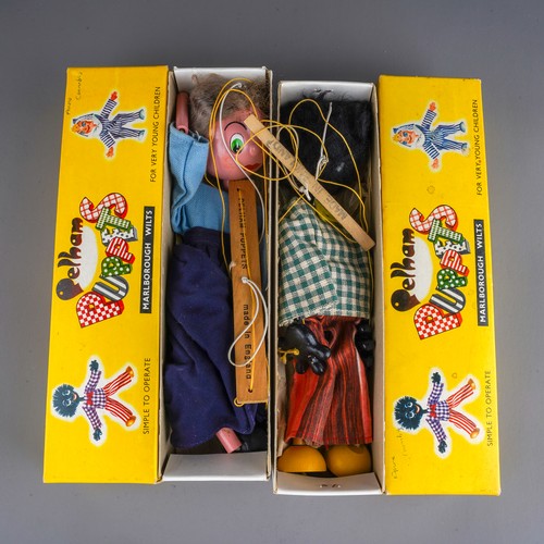 241 - Two vintage Pelham Puppets to include: Golliwog with gingham jacket and striped trousers, box with c... 