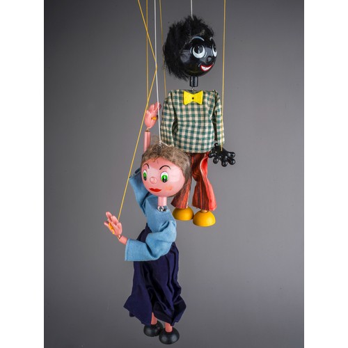 241 - Two vintage Pelham Puppets to include: Golliwog with gingham jacket and striped trousers, box with c... 