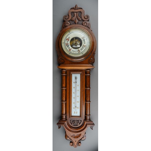 688 - A Victorian oak framed aneroid barometer, the carved case with pediment above column supports, the l... 