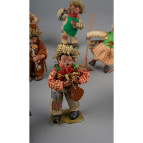 25 - Steiff: a collection of twelve Peter Figuren Mecki hedgehogs to include: monk, chimney sweep, skier,... 