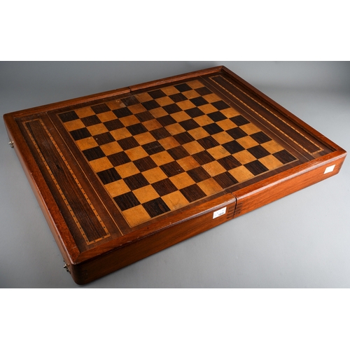 34 - Two vintage vari wood game boards with wooden draught pieces, the larger board with interior baize b... 