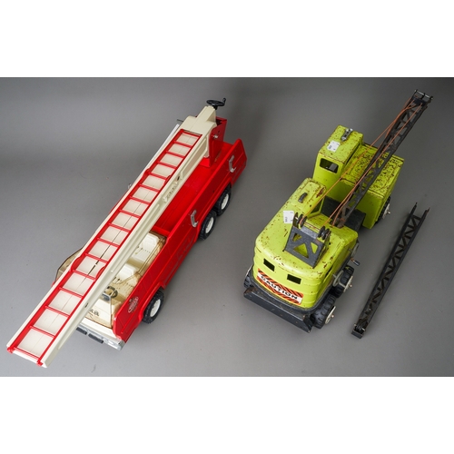 43 - Tonka Toys.  A large scale fire engine missing one ladder with a green Power House Earthmovers crane... 