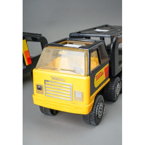 47 - Tonka Toys.  A pair of black/yellow articulated car transporters, one complete with 2 plastic cars. ... 