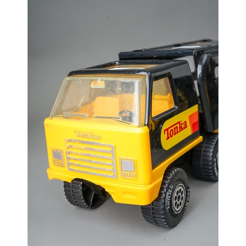 47 - Tonka Toys.  A pair of black/yellow articulated car transporters, one complete with 2 plastic cars. ... 