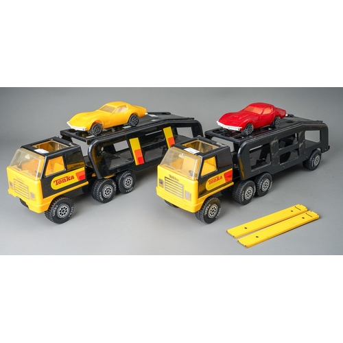 47 - Tonka Toys.  A pair of black/yellow articulated car transporters, one complete with 2 plastic cars. ... 