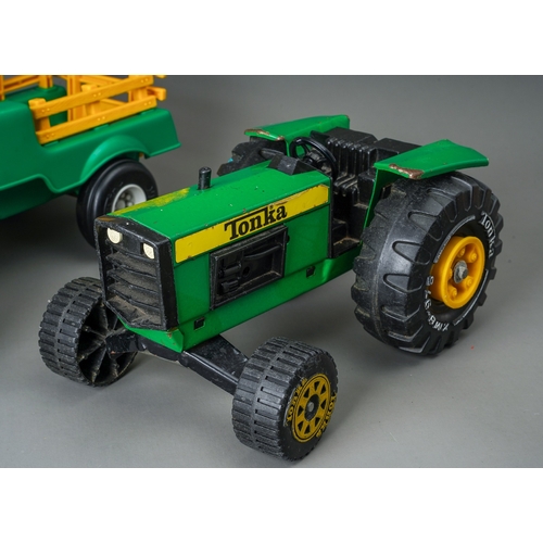 50 - Tonka Toys.  A green large scale tractor, together with a green/yellow plastic tractor and trailer (... 