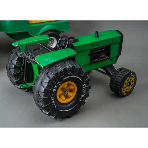 50 - Tonka Toys.  A green large scale tractor, together with a green/yellow plastic tractor and trailer (... 