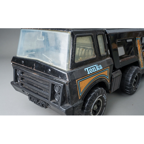 54 - Tonka Toys.  A large scale car carrier articulated lorry and trailer finished in black.  Damage to o... 