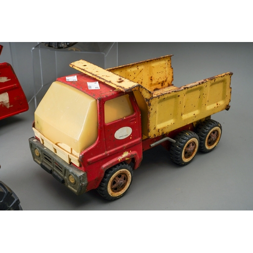 55 - Tonka Toys.  Four large scale vehicles - tractor, fire engine, dump truck and cement mixer, all requ... 