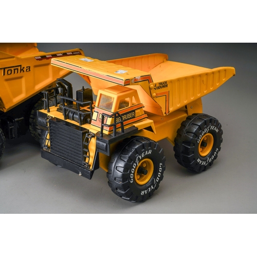 57 - Tonka Toys.  Three large scale dump trucks, all of differing designs (3)