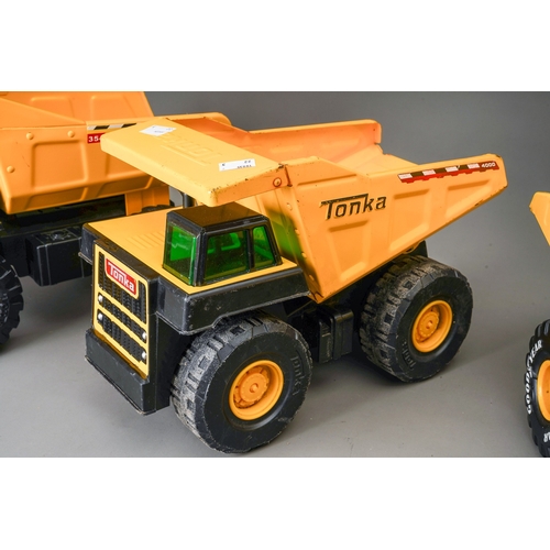 57 - Tonka Toys.  Three large scale dump trucks, all of differing designs (3)