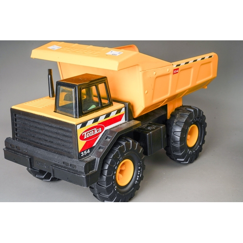 57 - Tonka Toys.  Three large scale dump trucks, all of differing designs (3)