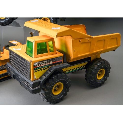 74 - Tonka Toys.  A collection of 4 large scale vehicles, 2 x dumper truck, 4 wheel crane truck and track... 