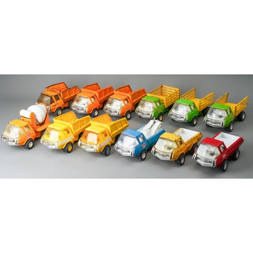 78 - Tonka Toys.  A mixed groups of 12 medium size 4 wheel trucks, different bodies and colours.  Mainly ... 