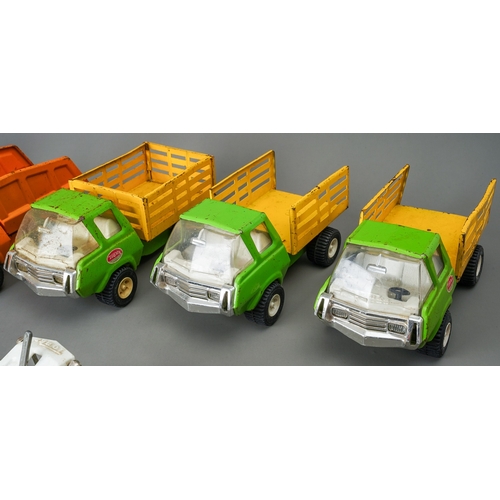 78 - Tonka Toys.  A mixed groups of 12 medium size 4 wheel trucks, different bodies and colours.  Mainly ... 