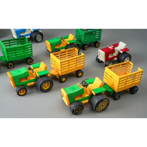 82 - Tonka Toys.  A quantity of small scale tractors and trailers