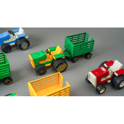 82 - Tonka Toys.  A quantity of small scale tractors and trailers