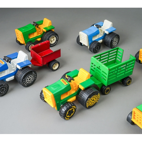 82 - Tonka Toys.  A quantity of small scale tractors and trailers