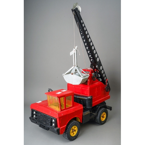 92 - Tonka Toys.  Large scale dumper truck and a 4 wheel crane truck in red with grab bucket (2)