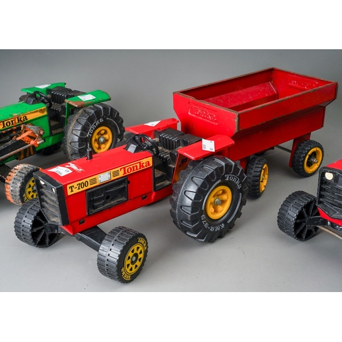 93 - Tonka Toys.  3 large scale tractors (2 red, 1 green) plus a red trailer (4)