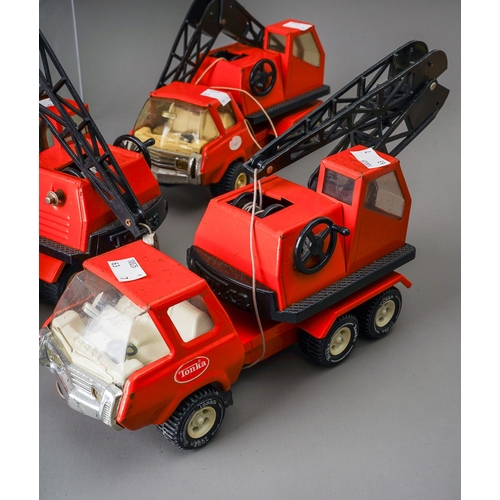 95 - Tonka Toys.  7 medium scale 6 wheel crane trucks in red, variable condition, some damaged (7)