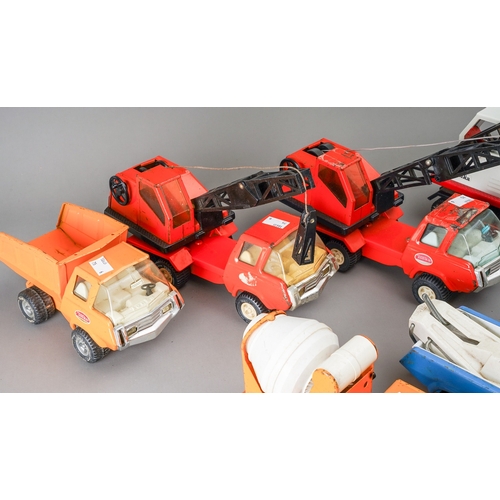 107 - Tonka Toys.  A selection of medium size 4 and 6 wheel wagons with differing body styles - cranes, ti... 