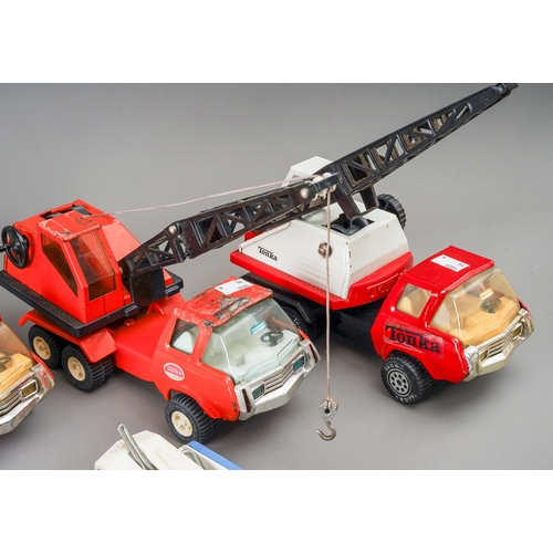 107 - Tonka Toys.  A selection of medium size 4 and 6 wheel wagons with differing body styles - cranes, ti... 