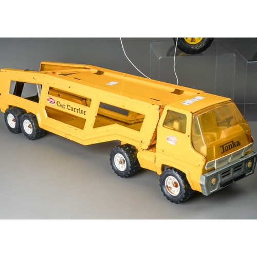 113 - Tonka Toys.  Two car carrier transporter articulated lorries (one black, one yellow) of medium size ... 