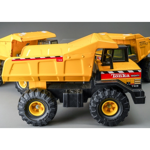 116 - Tonka Toys.  Three examples of Mighty dump trucks, two have clear glazing to cab, one has green glaz... 