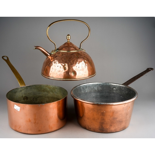 139 - A late 19th Century large copper kettle together two two large copper pans, one stamped 24