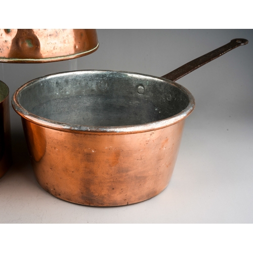 139 - A late 19th Century large copper kettle together two two large copper pans, one stamped 24