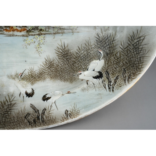 173 - An early 20th Century Japanese Export oval earthenware dish, the entire painted with river landscape... 